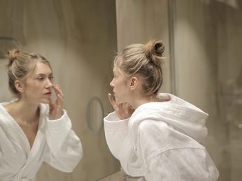 girl looking into mirror
