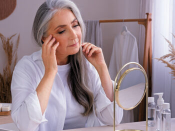 Woman looking into mirror