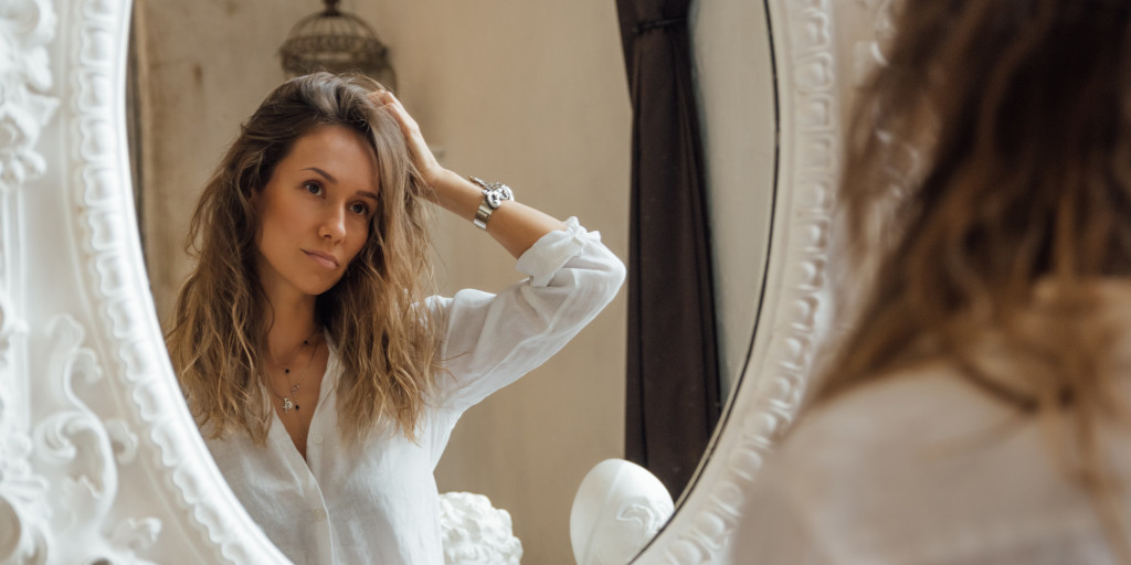 girl looking into mirror