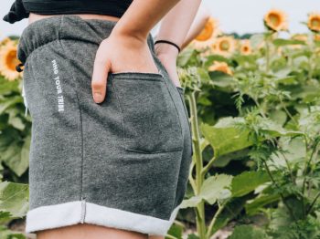 grey shorts and sunflower feild