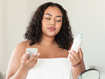 woman reading skin care product label