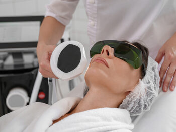 woman getting facial laser treatment